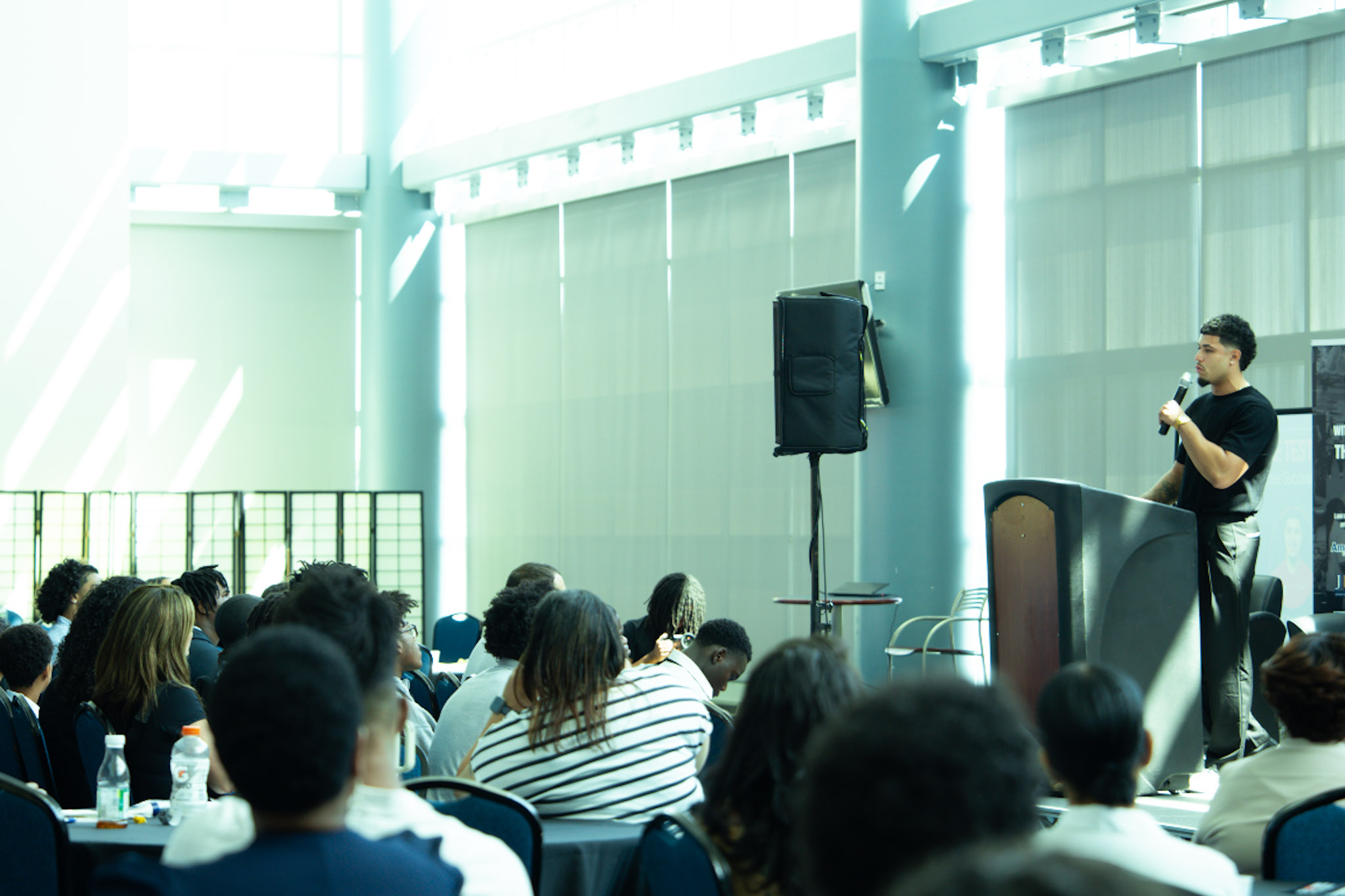 Speaker addressing a packed room at the Summit